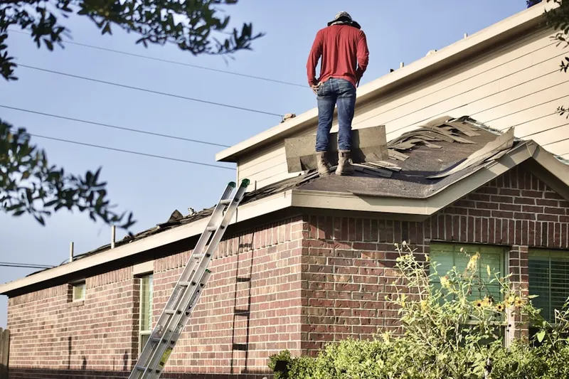 Professional roofer working on a residential roof in River Grove
